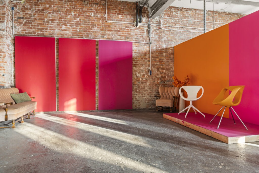 Bunte Waende mit Designerstuehlen in Studio 2 des Brixx Loftstudio Hannover